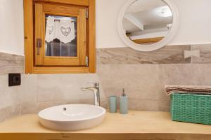 a bathroom with a sink and a mirror at Les Cles - Genepy in Valsavarenche +23 photos