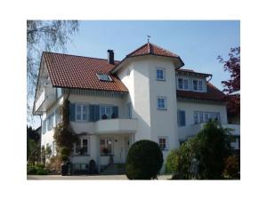 a large white house with a red roof at Haus Schnitzler in Wasserburg +9 photos