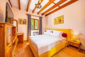 a bedroom with a bed and a television in it at Es Pouet in Binissalem