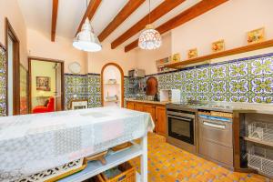 a kitchen with a counter and a stove top oven at Es Pouet in Binissalem