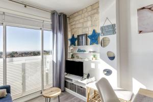 a living room with a desk and a tv at Ventana Loft in Empuriabrava