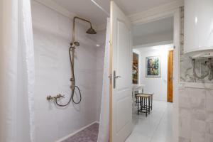 a white bathroom with a shower and a walk in shower at La Fabriqueta Studio in Ríudecañas +12 photos