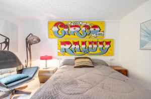a bedroom with a bed and a chair at La Fabriqueta Studio in Ríudecañas