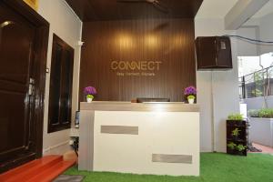 an office with a counter with a sign on the wall at Connect Backpackers Hostel in Chennai