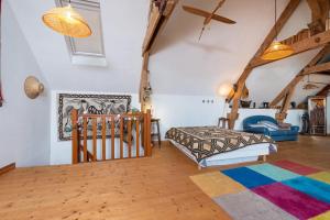 a bedroom with a bed and a crib in a room at Longère de charme in Kervignac +24 photos