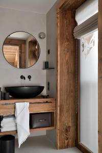 a bathroom with a black sink and a mirror at Chalet Enigma in La Clusaz +16 photos