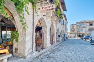 a cobblestone street in a town with a sign on a building at Gite L'Envie d'Eymet in Eymet