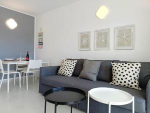 a living room with a blue couch and a table at Torres in Antigua