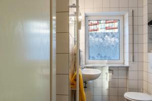 a bathroom with a sink and a window at Ferienwohnung Tannenblick 1-3 in Oberhof +18 photos