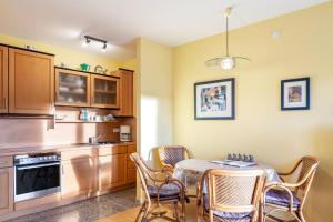 a kitchen with a table and chairs in a room at Ferienwohnung Tannenblick 1-3 in Oberhof