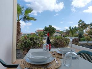 a table with plates and wine glasses on a balcony at Torres in Antigua
