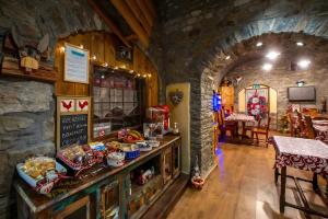 a restaurant with a counter with food on it at Arthemisia - Rhêmes-Notre-Dame in Rhêmes-Notre-Dame