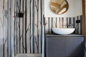 a bathroom with a sink and a mirror at Bellagio - Baita treeb Breva in Bellagio +37 photos