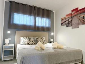 a bedroom with a large bed with two towels on it at Torres in Antigua +24 photos