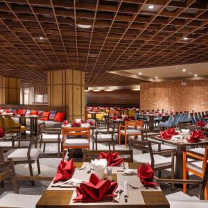 a restaurant with tables and chairs with red napkins at Apec Beach Luxury Phú Yên in Tuy Hoa