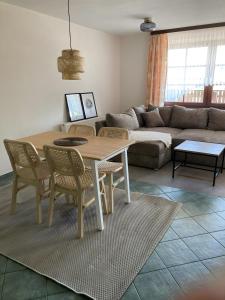 a living room with a table and chairs and a couch at Ferienwohnungen am Louisenteich in Frauendorf +23 photos