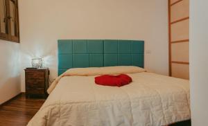 a bedroom with a bed with a red pillow on it at Appartamento Panorama in Ostuni