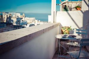 a table and chairs on a balcony with a view at Appartamento Panorama in Ostuni +9 photos
