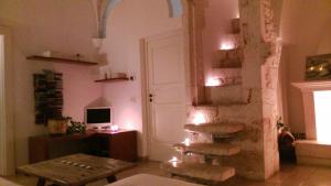 a living room with a ladder and a table and a door at Appartamento Panorama in Ostuni
