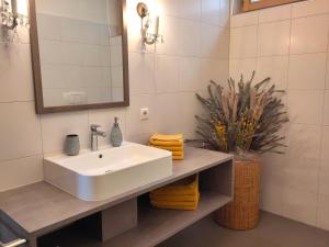 a white bathroom with a sink and a mirror at Apartment Matthäus in Cermes