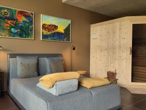 a bed with two pillows on it in a room at Apartment Matthäus in Cermes