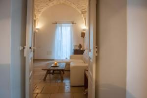 a living room with a couch and a table at Appartamento Panorama in Ostuni