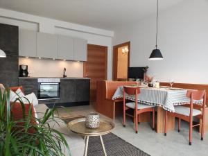 a kitchen and living room with a table and chairs at Apartment Matthäus in Cermes