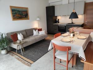 a living room with a table and a couch at Apartment Matthäus in Cermes +15 photos