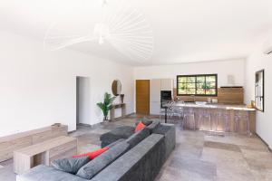 a living room with a couch and a kitchen at Villa Catherine in Ghisonaccia