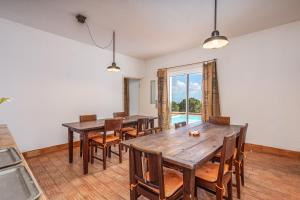a dining room with wooden tables and chairs at Alto da Lua in Bordeira