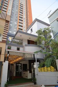 a building with a sign in front of it at Connect Backpackers Hostel in Chennai