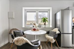 a kitchen with a table and chairs and a refrigerator at Mika in Oesterdeichstrich