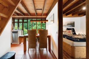 a kitchen and dining room with a table and chairs at Ferienhaus Karlsminde in Waabs