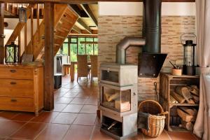a wood stove in a room with a table at Ferienhaus Karlsminde in Waabs