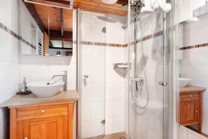 a bathroom with a shower and a sink at Ferienhaus Karlsminde in Waabs +25 photos