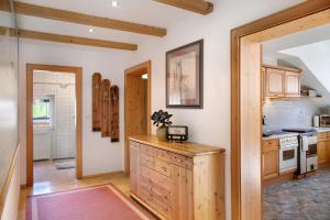 a kitchen with wooden cabinets and a counter top at Hof Almfrieden - Dormitz in Nassereith