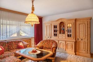 a living room with a couch and a table at Hof Almfrieden - Dormitz in Nassereith
