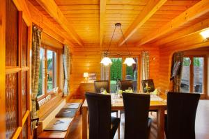 a dining room with a table and chairs at Holzhaus Zum Radekopf mit Whirlpool in Medebach