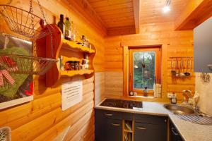 a kitchen in a log cabin with a sink at Holzhaus Zum Radekopf mit Whirlpool in Medebach +27 photos