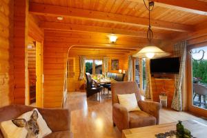 a living room with wooden walls and a dining room at Holzhaus Zum Radekopf mit Whirlpool in Medebach