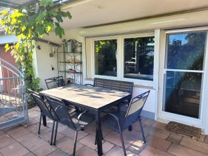 a table and chairs on a patio with windows at Ferienwohnung Brixius in Koblenz