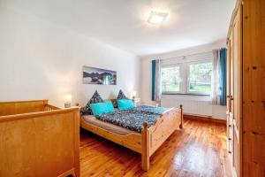 a bedroom with a bed with blue pillows at Domäne Bollinger Morbach in Morbach