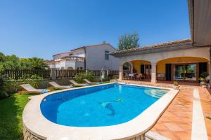 a swimming pool in the backyard of a house at Ca Na Rosa in Alcudia