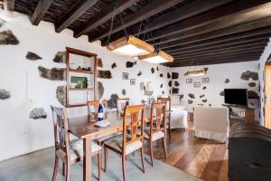 a dining room with a wooden table and chairs at El Lagar in Frontera
