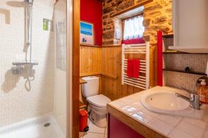 a bathroom with a toilet and a sink and a shower at Ville Moizo in Sérent +19 photos