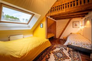 a bedroom with two beds and a window at Ville Moizo in Sérent