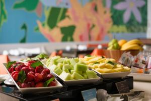 a buffet with several plates of fruit on a table at Hotel Terrado Lyon in Santiago