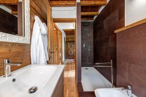 a bathroom with a white tub and a sink at Nini's Home in Schignano +20 photos