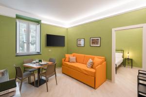 a living room with a couch and a table at Dimora Borgo Antico Lucia in Ascea