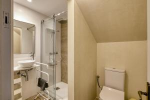 a bathroom with a toilet and a sink at Casa adosada in Begur +17 photos